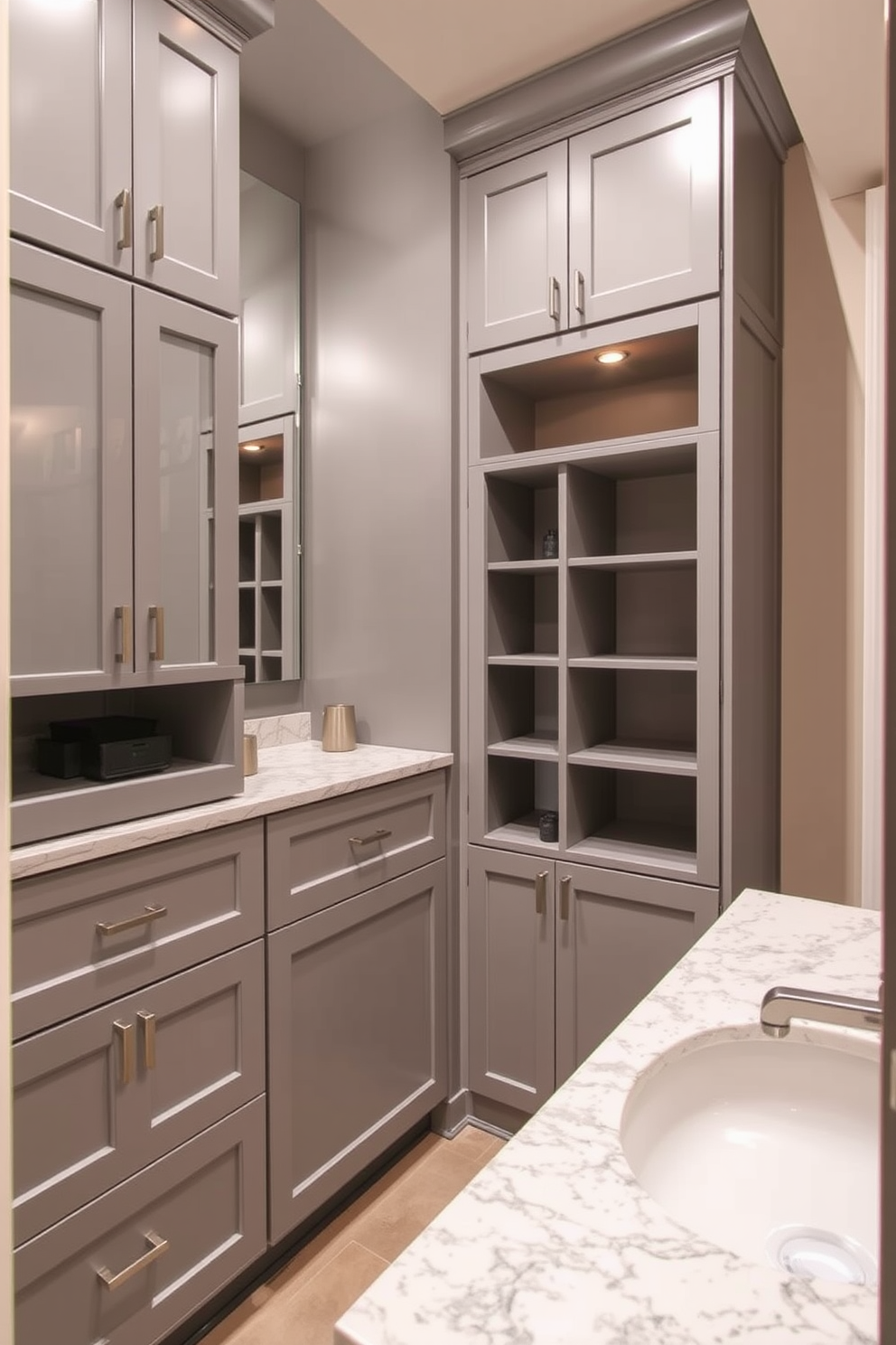 Custom cabinetry for tailored storage in a basement bathroom. The cabinetry features a sleek design with a combination of open shelves and closed compartments, finished in a soft gray tone to enhance the space. The countertop is a polished quartz with subtle veining, complemented by stylish hardware in brushed nickel. A large mirror above the sink reflects the warm lighting, creating an inviting atmosphere in the basement retreat.