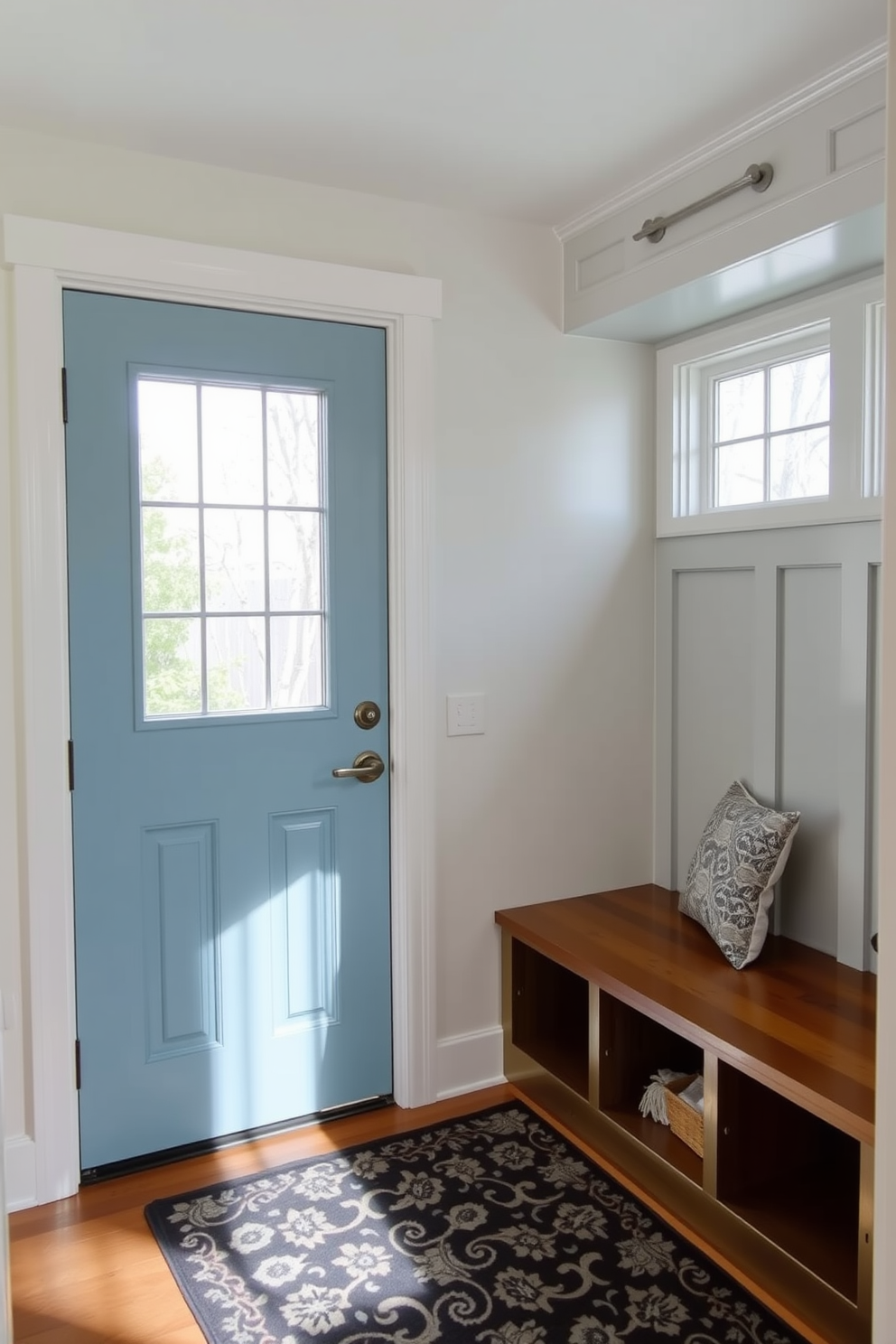 A charming mudroom featuring a robin's egg blue door flanked by elegant sidelights. The space is designed with built-in benches and storage cubbies, complemented by a patterned area rug that adds warmth.