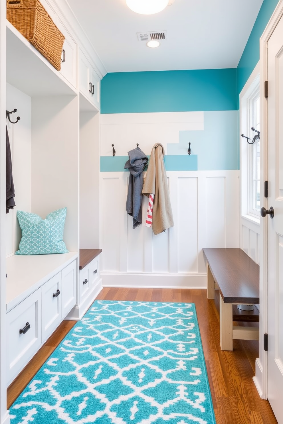 A bright and inviting mudroom features a turquoise accent rug that beautifully contrasts with the neutral tones of the walls and cabinetry. The space includes built-in storage benches and hooks for coats, creating a functional yet stylish entryway.