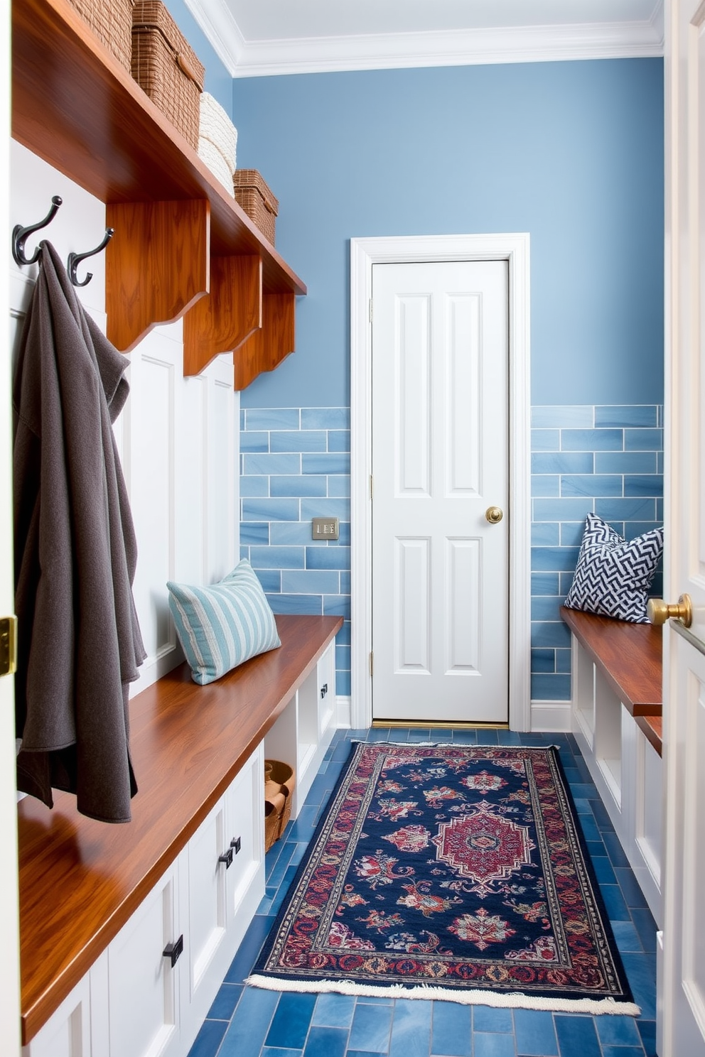 A stylish mudroom featuring ocean blue tile flooring that enhances durability and adds a pop of color. The space includes built-in storage benches with hooks above for coats, and a decorative rug that complements the blue tones.