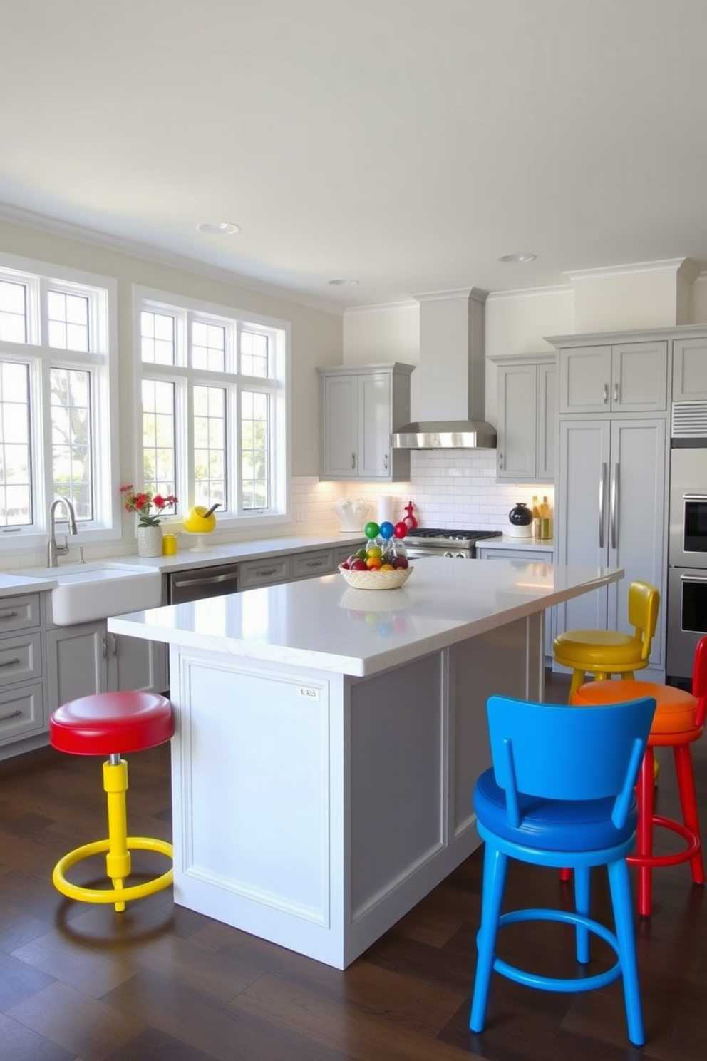 Colorful bar stools surround a spacious neutral island in a bright and inviting kitchen. The island features a smooth white countertop, complemented by vibrant bar stools in shades of blue, yellow, and red, creating a lively focal point in the room. The cabinetry is a soft gray, providing a subtle backdrop that enhances the colorful accents. Large windows allow natural light to flood the space, highlighting the playful design elements and creating an atmosphere perfect for entertaining.