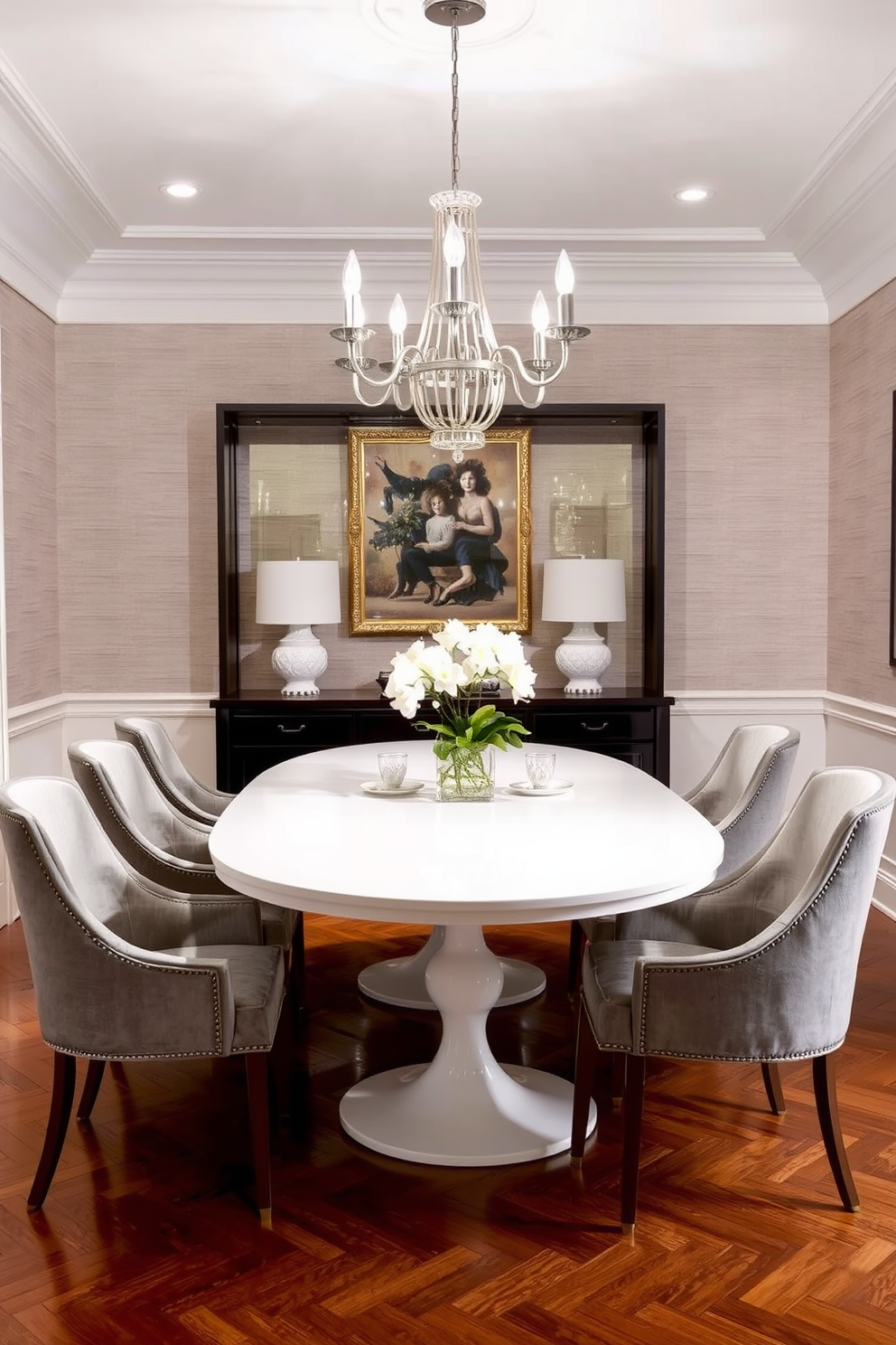 A chic white lacquered dining table is the centerpiece of the dining room, surrounded by elegant upholstered chairs in a soft gray fabric. The walls are adorned with subtle textured wallpaper, and a statement chandelier hangs above, casting a warm glow over the space.