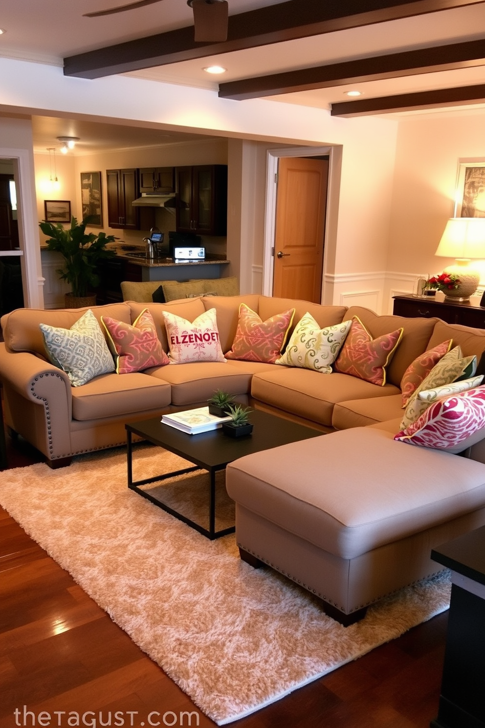 Cozy sectional sofa with colorful pillows in a warm family room. The walls are painted in soft beige, and a large area rug with a geometric pattern anchors the seating area.