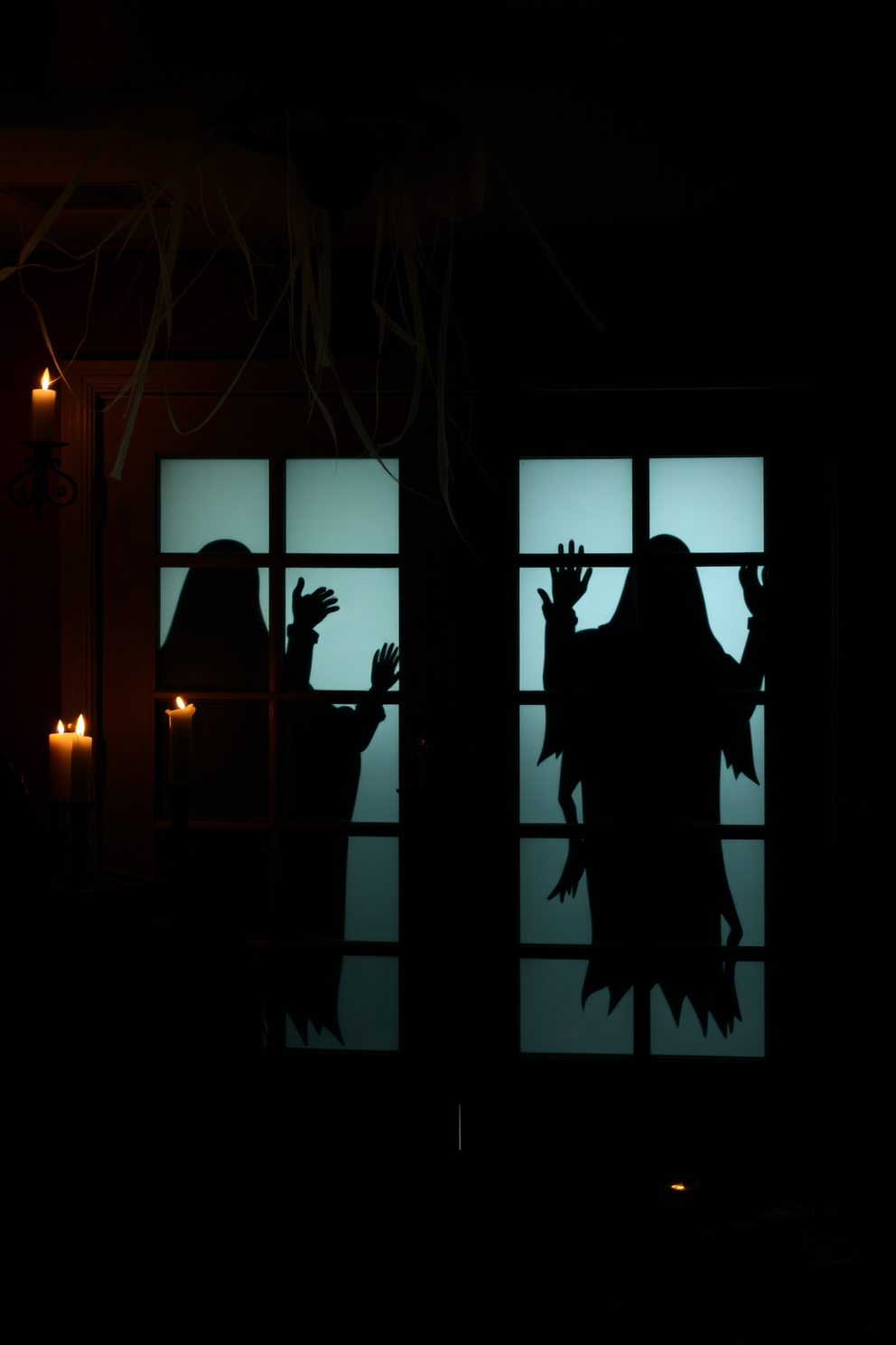 Create an eerie basement setting for Halloween featuring ghostly silhouettes on glass doors. The room is dimly lit with flickering candles casting shadows, and cobwebs drape from the ceiling.