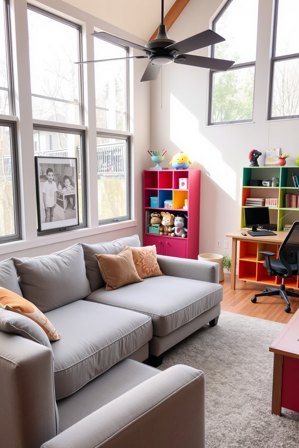 A cozy home office and playroom combo features a plush sectional sofa in a soft gray fabric, perfect for relaxation and unwinding. The space is brightened by large windows that allow natural light to flood in, creating an inviting atmosphere for both work and play. Adjacent to the sofa, a sleek wooden desk is set against the wall, equipped with modern office supplies and a comfortable ergonomic chair. Colorful shelving units display toys and books, blending functionality with a playful aesthetic to inspire creativity in both adults and children.