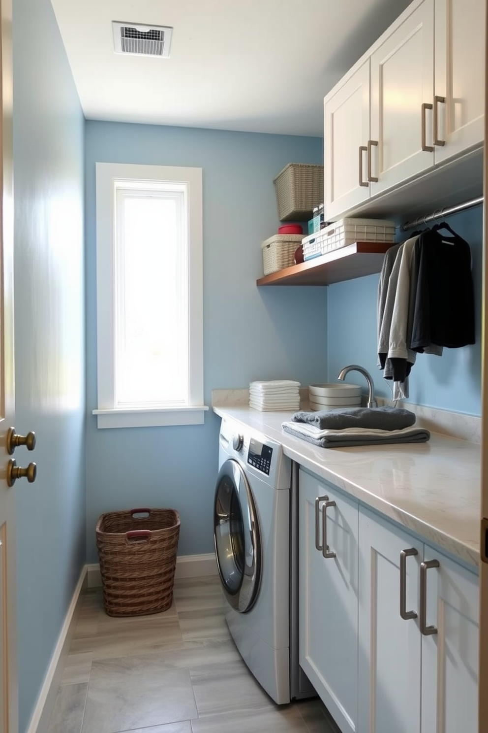 A functional laundry room featuring a top loading washer surrounded by ample counter space for folding clothes. The walls are painted in a light blue hue, and the floor is adorned with durable vinyl tiles for easy maintenance. A wall-mounted shelf holds neatly organized laundry supplies, while a stylish basket sits beneath the counter for sorting clothes. Natural light streams in through a window, enhancing the bright and airy feel of the space.