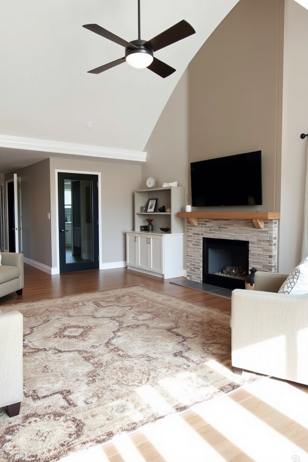 A cozy living room featuring a large area rug that defines the seating area. The room includes a stylish fireplace with a modern mantel and a flat-screen TV mounted above it.