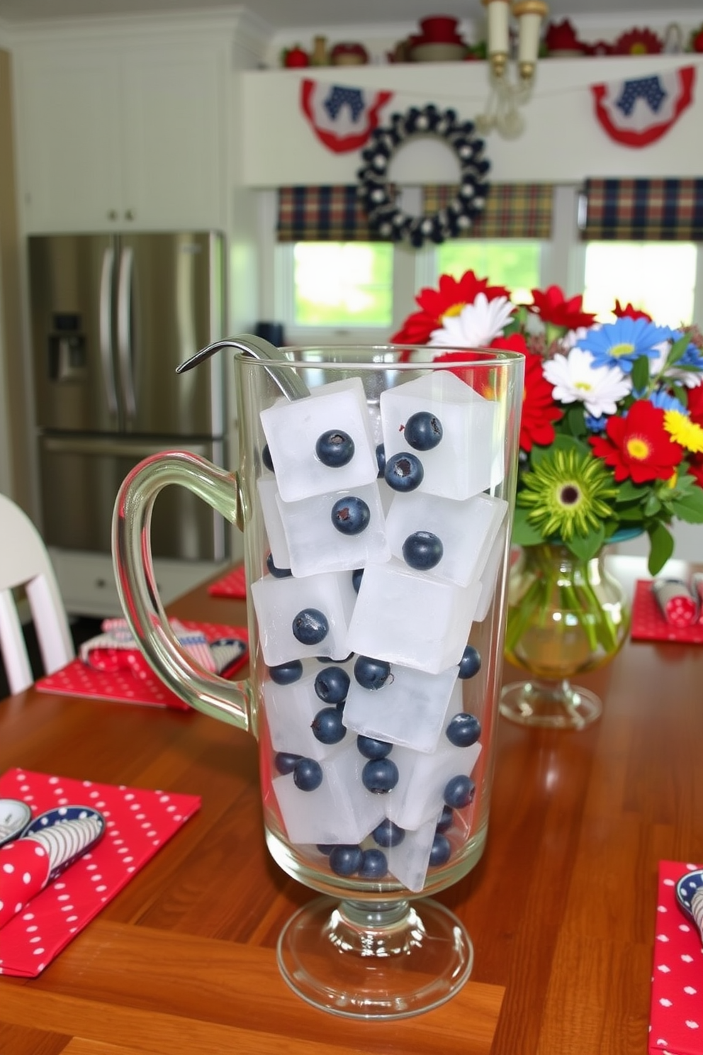 Festive ice cubes filled with fresh blueberries are arranged in a clear glass pitcher, ready to elevate summer drinks at your Memorial Day gathering. The kitchen is adorned with red, white, and blue decorations, featuring a cheerful table setting that includes star-spangled napkins and vibrant floral centerpieces.