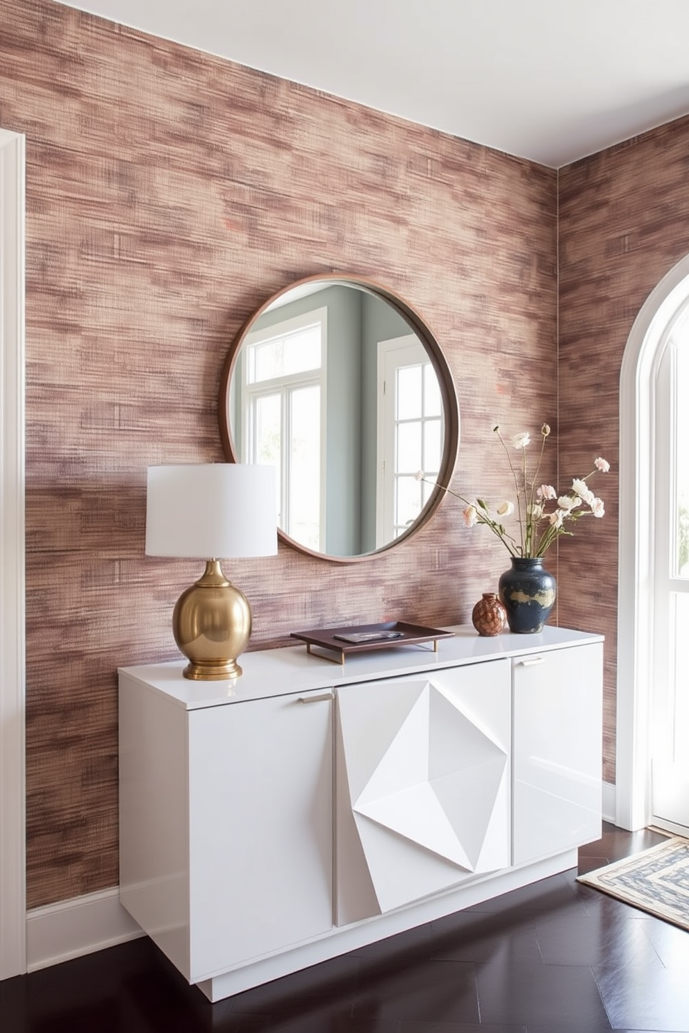 A Mid Century Modern foyer featuring textured wallpaper that adds depth and interest to the space. The foyer includes a sleek console table with a geometric design and a large round mirror above it, reflecting natural light from a nearby window.