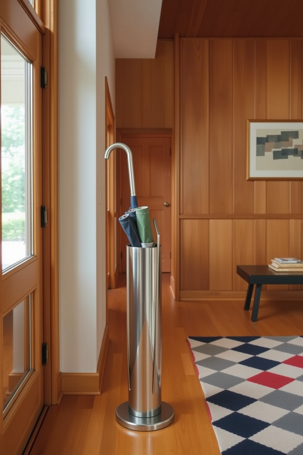 A stylish umbrella stand is positioned elegantly near the entrance, crafted from sleek metal with a minimalist design. The foyer features warm wood paneling and a striking geometric rug that complements the Mid Century Modern aesthetic.