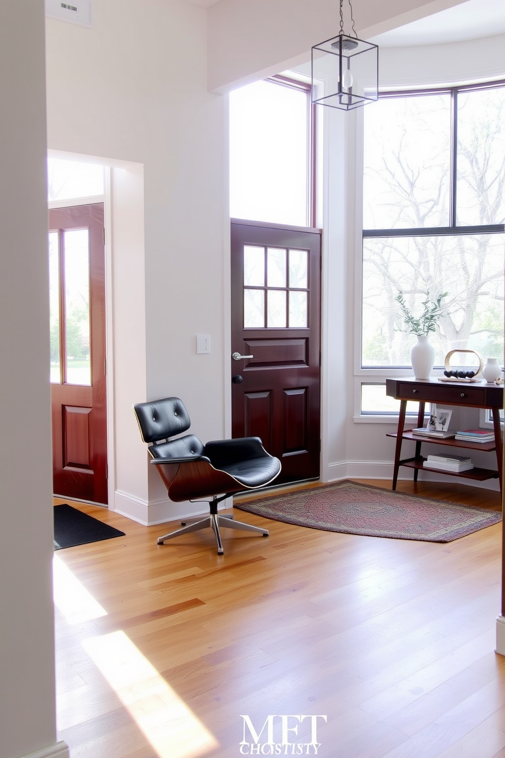 A classic Eames chair is positioned in the corner of the foyer, showcasing its iconic design and sleek lines. The walls are painted in a soft neutral color, complementing the warm wood tones of the flooring and creating an inviting atmosphere. A stylish console table sits against the opposite wall, adorned with a few carefully selected decorative items. Natural light floods the space through a large window, enhancing the airy feel of this Mid Century Modern foyer.