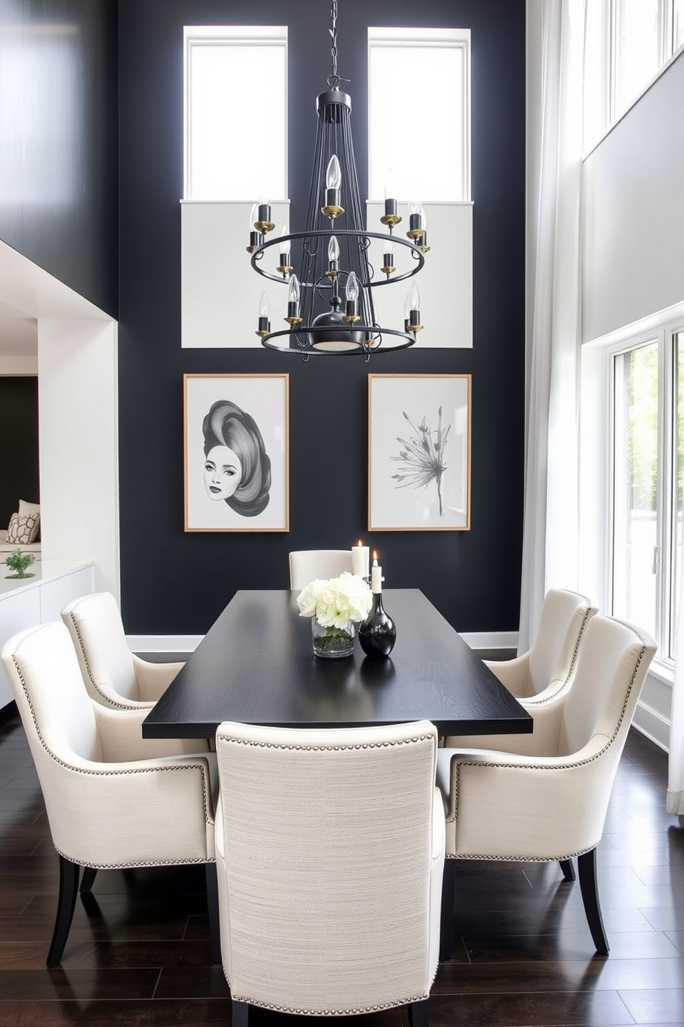 A modern dining room featuring a sleek dark wood table surrounded by light upholstered chairs. The walls are painted in a soft white, while a bold black accent wall adds depth to the space. A stunning chandelier with a mix of black and gold finishes hangs above the table, casting a warm glow. Large windows draped with sheer white curtains allow natural light to flood in, enhancing the contrast between the dark and light elements.