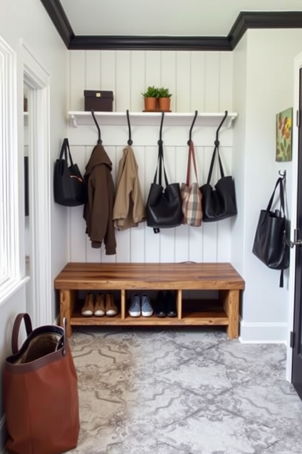 A functional wall-mounted bench with seating is the focal point of a modern mudroom. The bench is crafted from reclaimed wood and features ample storage space underneath for shoes and outdoor gear. Surrounding the bench are stylish hooks for hanging coats and bags, creating an organized and inviting entryway. The walls are painted in a crisp white, complemented by a durable, patterned tile floor that adds a touch of elegance.