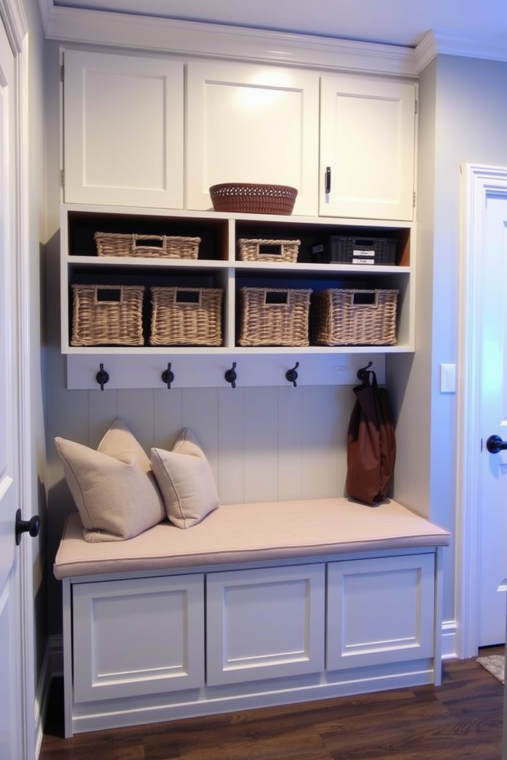 A cozy mudroom featuring open shelving above a spacious bench. The bench is upholstered in a soft fabric, providing comfort while the shelves are filled with neatly organized baskets and decorative items.