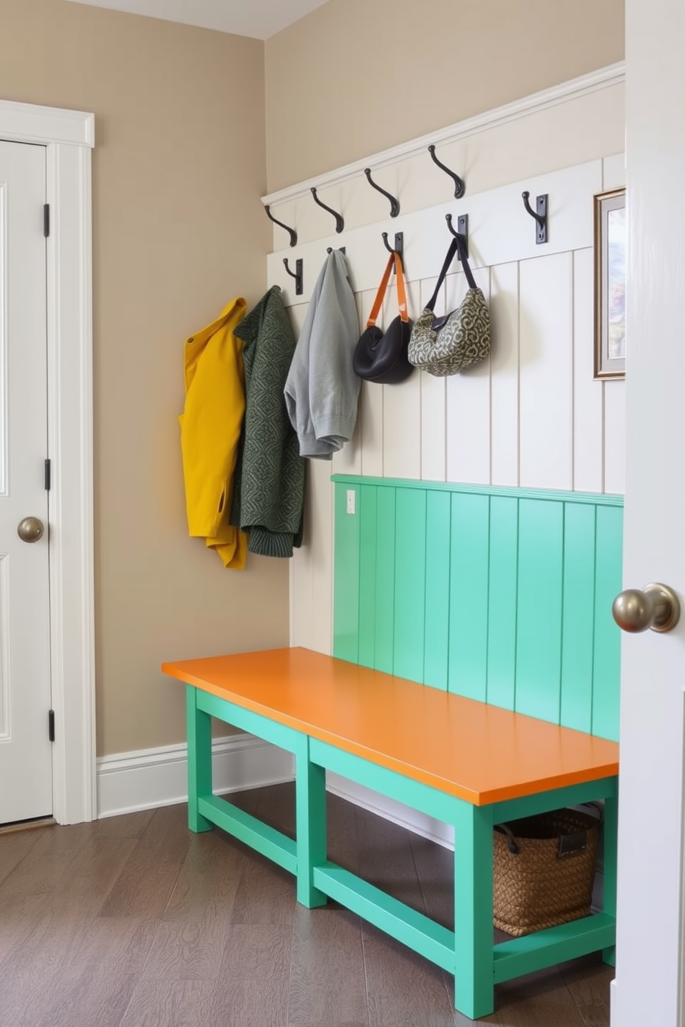 A brightly painted bench serves as a stunning focal point in the mudroom. The bench features a vibrant color that contrasts beautifully with the neutral tones of the surrounding walls and floor. Above the bench, there are hooks for hanging coats and bags, adding functionality to the design. The floor is adorned with a durable, easy-to-clean material that complements the overall aesthetic of the space.