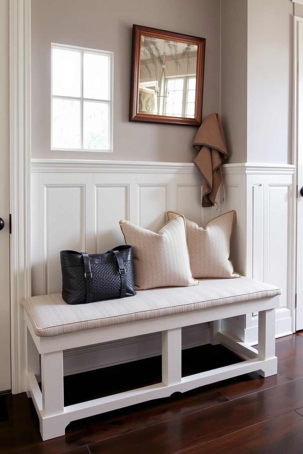 A classic bench with elegant wainscoting details is placed against the wall in a stylish mudroom. The bench features plush cushions in a neutral fabric, providing comfort while maintaining a refined aesthetic.