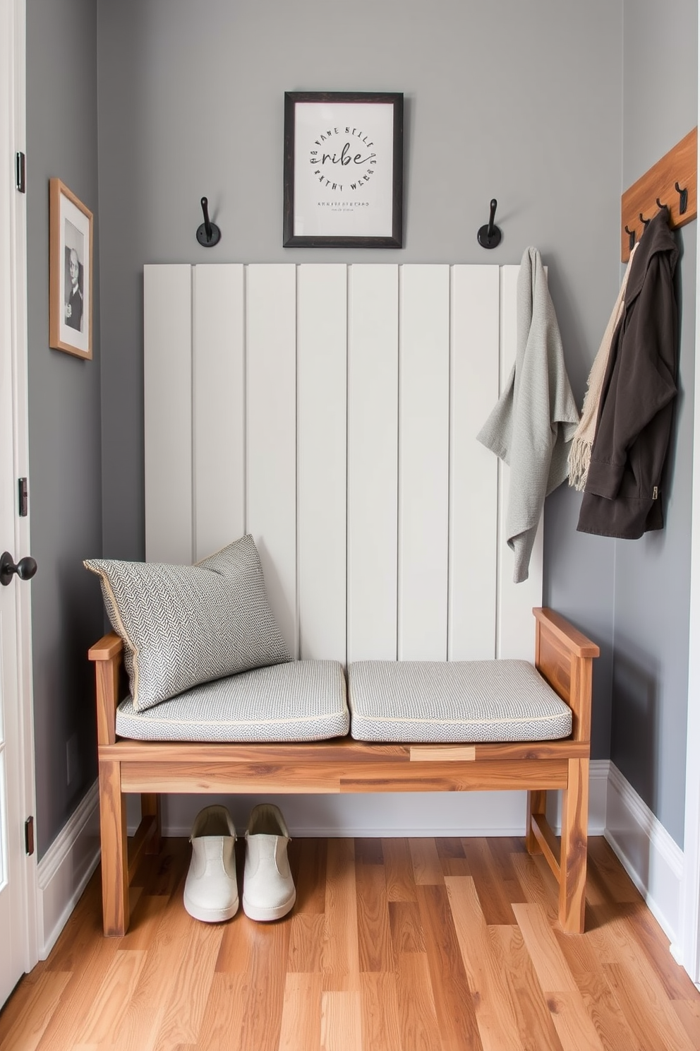 A stylish mudroom featuring a foldable bench that allows for versatility in space usage. The bench is crafted from reclaimed wood with a natural finish, complemented by soft cushions in a neutral fabric for comfort.