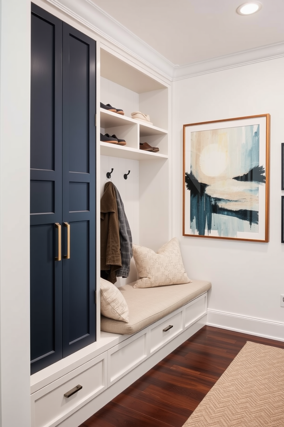 A stylish mudroom featuring a built-in closet with ample storage. The closet has open shelves for shoes and hooks for coats, accented by a bench with soft cushions for comfort. Artwork is displayed on the walls to add a personal touch and character to the space. A large framed piece of abstract art complements the mudroom's color scheme, creating a welcoming atmosphere.
