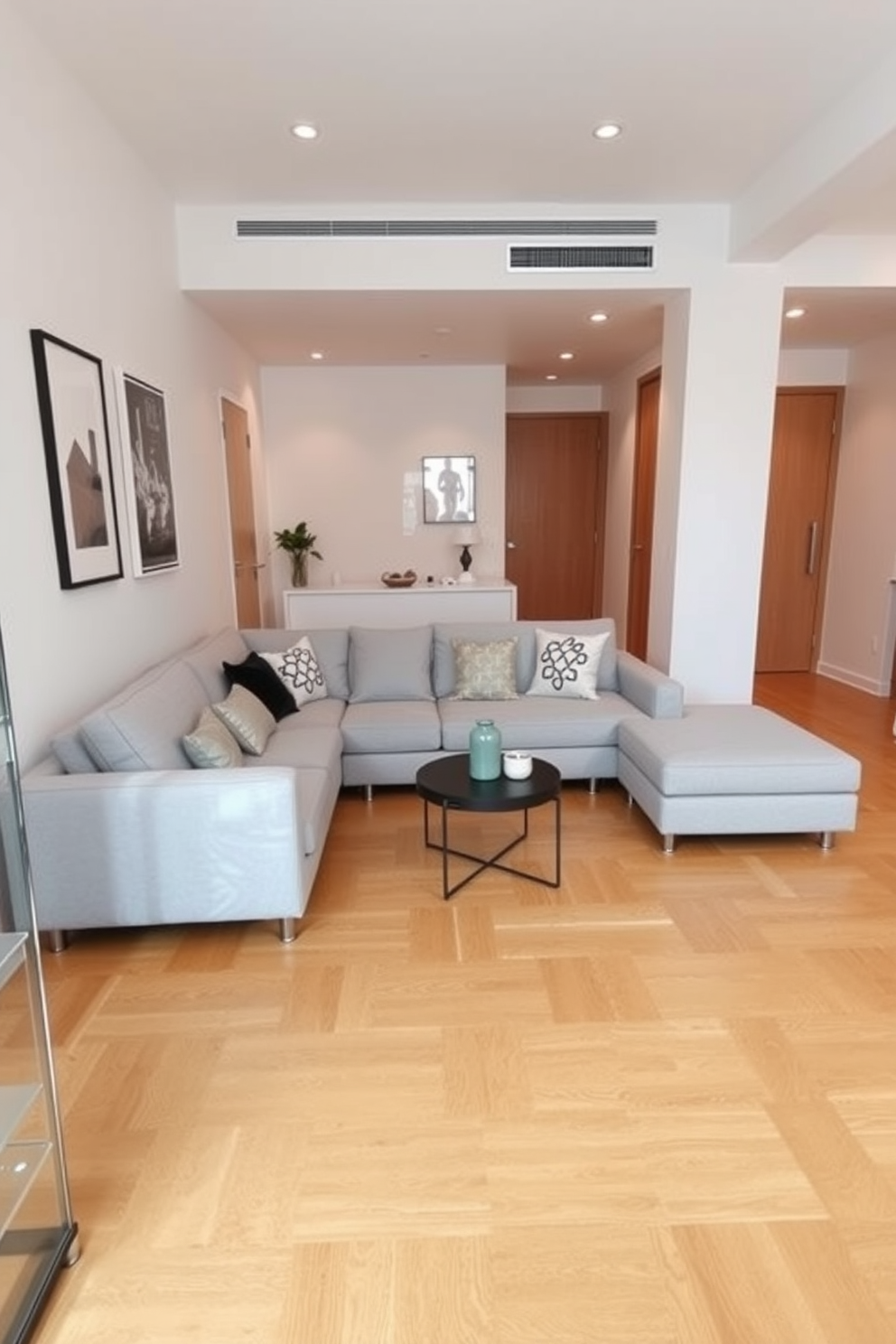 A stylish sectional sofa is positioned in the corner of a narrow apartment living room. The sofa features a sleek design with a light gray fabric that complements the warm wood tones of the flooring. The walls are adorned with minimalist art pieces that enhance the modern aesthetic. A small coffee table sits in front of the sofa, surrounded by a few decorative cushions for added comfort.