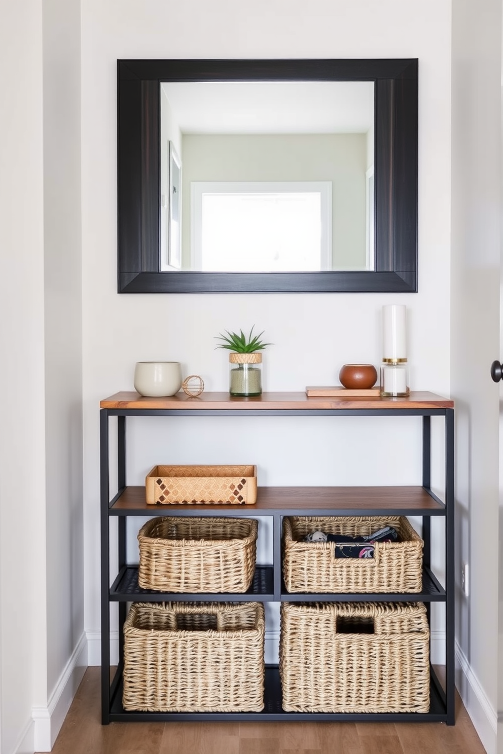 A stylish console table with storage options is placed against the wall in a narrow entryway. The table features a sleek design with a mix of wood and metal, complemented by decorative items and a small potted plant on top. The walls are painted in a soft neutral color to enhance the space, while a large mirror above the console reflects light and creates an illusion of depth. Underneath, woven baskets provide practical storage for shoes and accessories, adding both function and style.