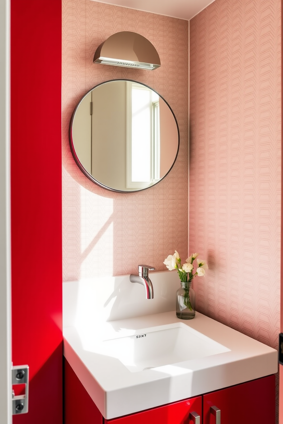 Contemporary red cabinetry with sleek lines creates a bold statement in this powder room. The cabinetry features minimalist hardware and is complemented by a chic white countertop that enhances the modern aesthetic. The walls are adorned with a subtle geometric wallpaper, adding depth and texture to the space. A stylish round mirror hangs above the sink, reflecting the vibrant cabinetry and illuminating the room with warm light.