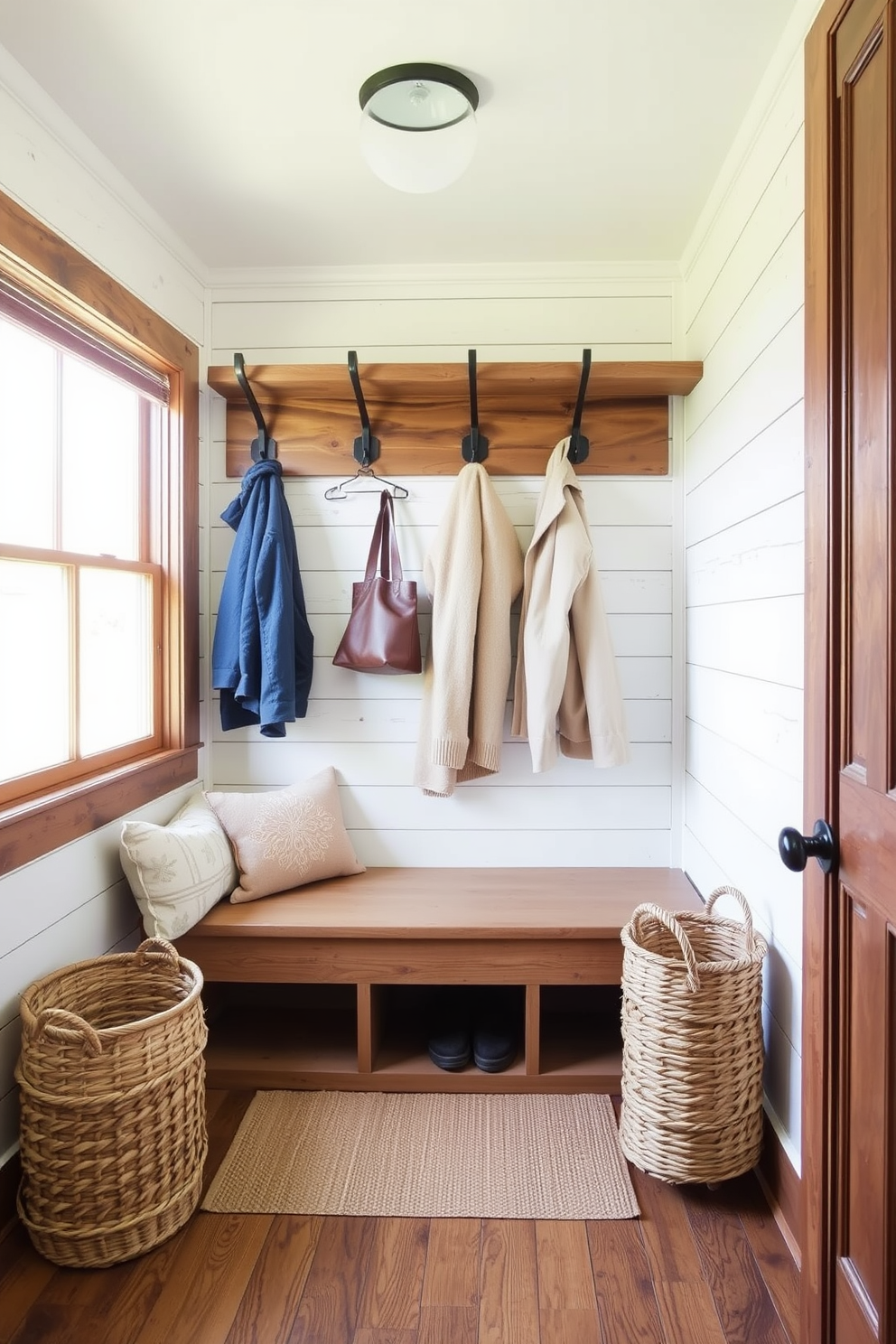 Create a cozy mudroom featuring reclaimed wood wall paneling that adds warmth and character. The space includes built-in wooden benches with soft cushions, hooks for coats, and a rustic storage cabinet for shoes and outdoor gear.