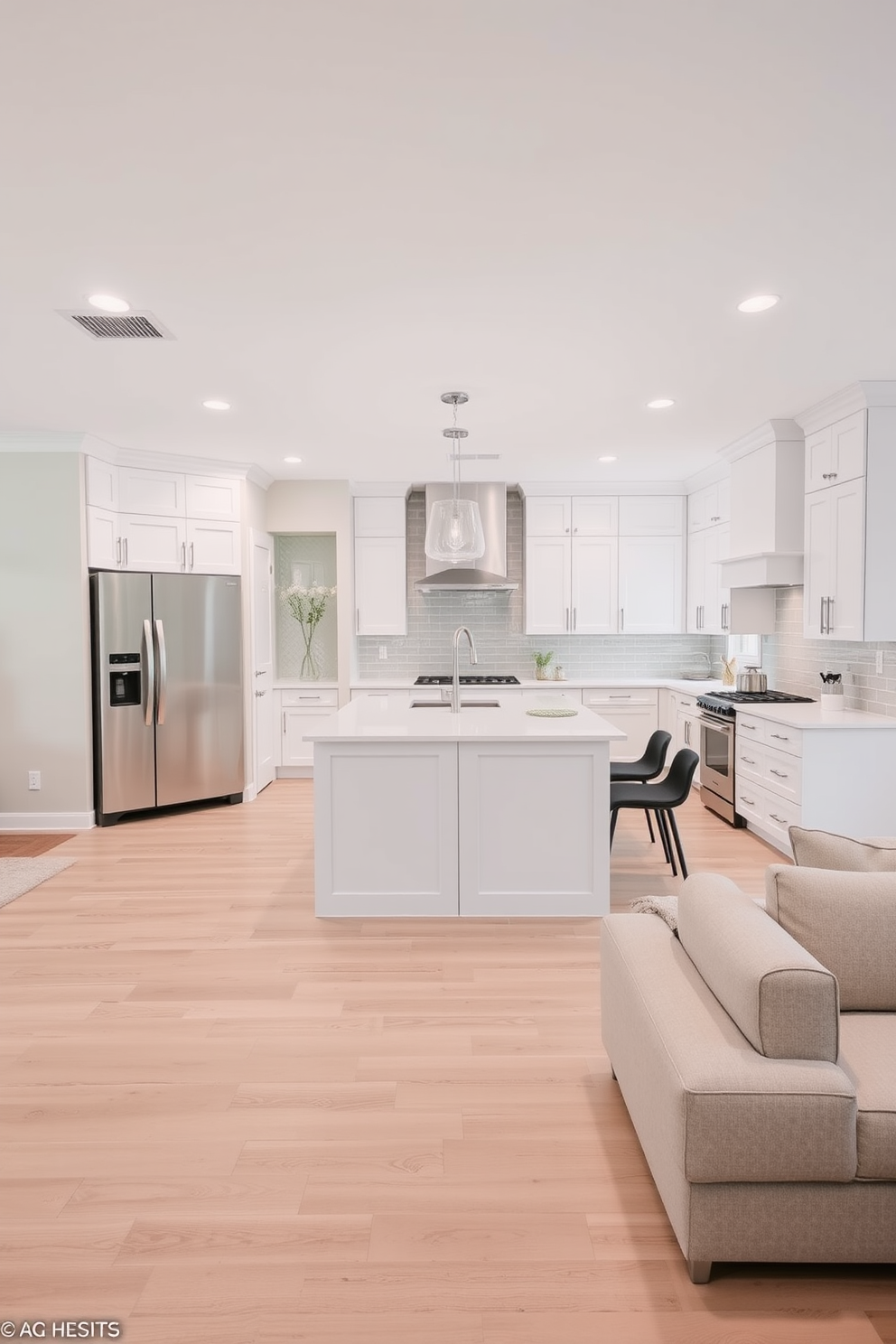 A simple kitchen design features a large island with a white quartz countertop and sleek cabinetry in soft gray. The backsplash is adorned with white subway tiles, and a patterned rug adds a touch of warmth and visual interest underfoot.