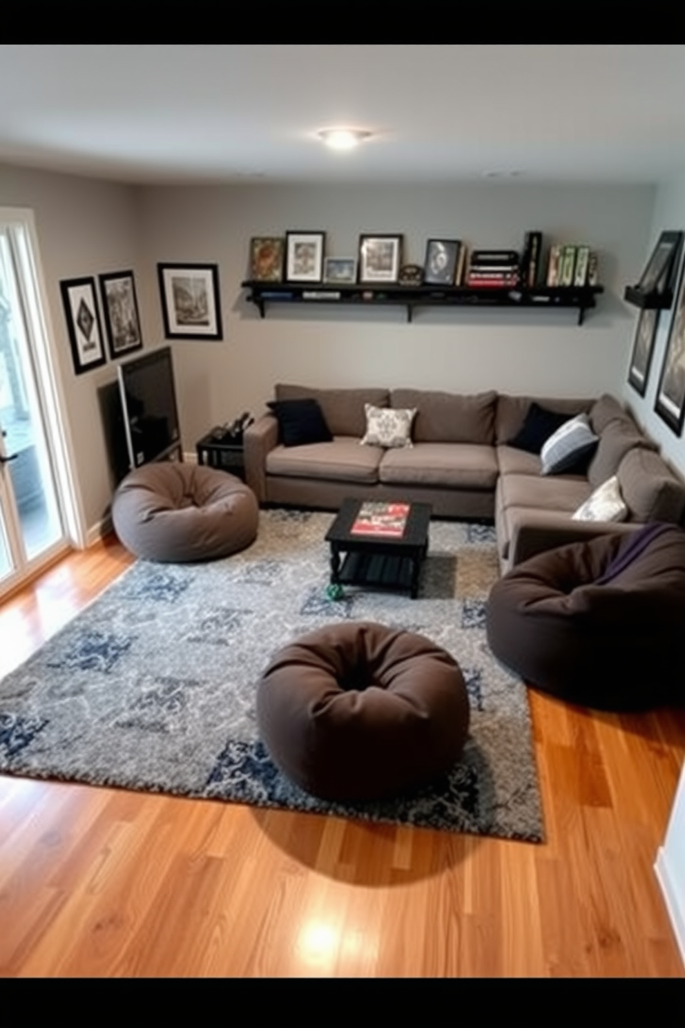 A cozy game room featuring a plush area rug that defines the gaming zone. The rug is in a geometric pattern with shades of blue and gray, providing a contrast to the hardwood floor. Surrounding the rug are comfortable seating options, including a sectional sofa and bean bags for a relaxed atmosphere. The walls are adorned with framed artwork and shelves displaying board games and collectibles for added personality.