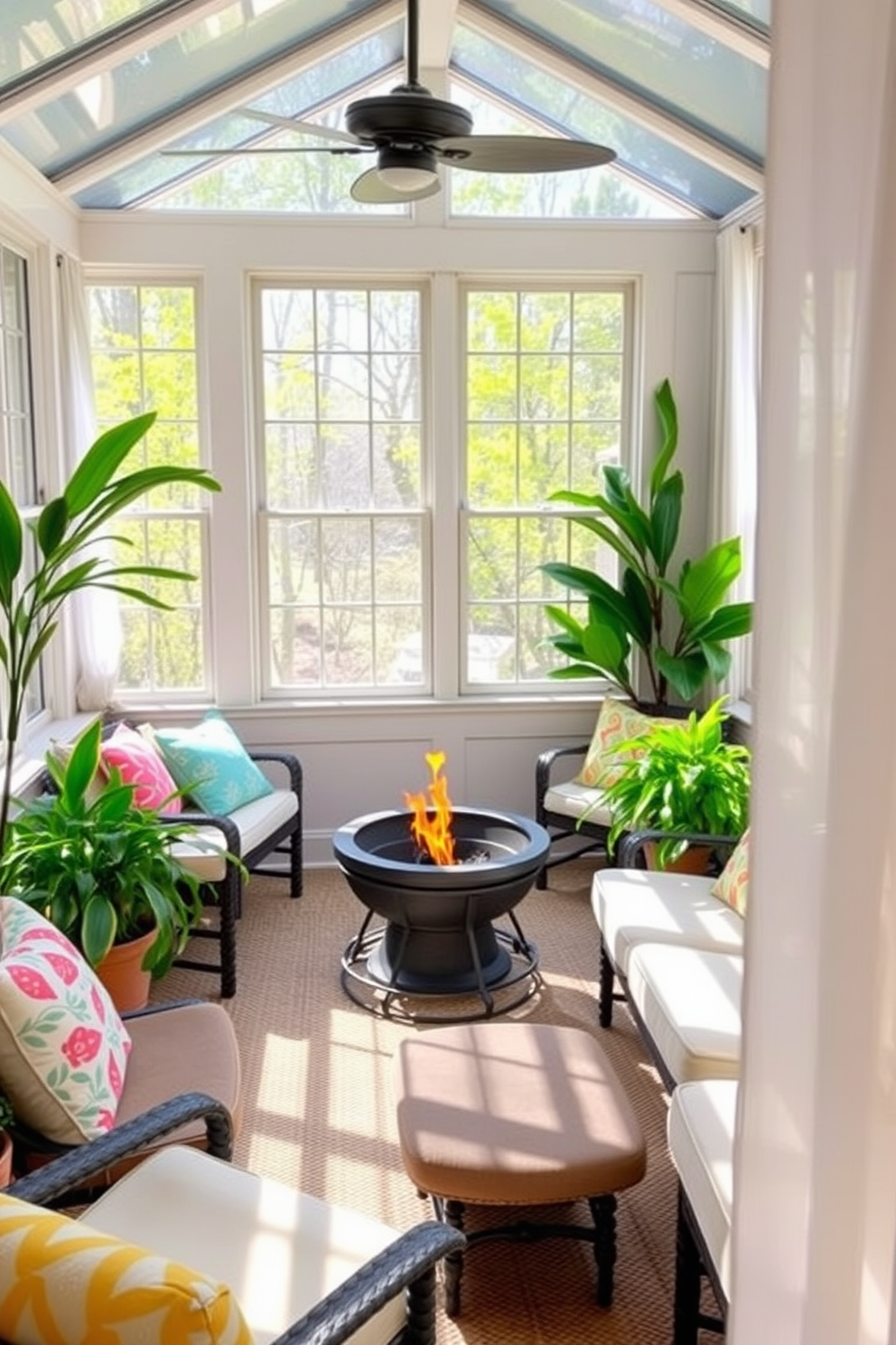 A cozy sunroom filled with natural light features a small fire pit at its center, surrounded by comfortable seating. Lush green plants adorn the corners, while colorful cushions add a pop of vibrancy to the space. Large windows invite the spring breeze, creating an inviting atmosphere. Soft, sheer curtains flutter gently, enhancing the room's airy feel.