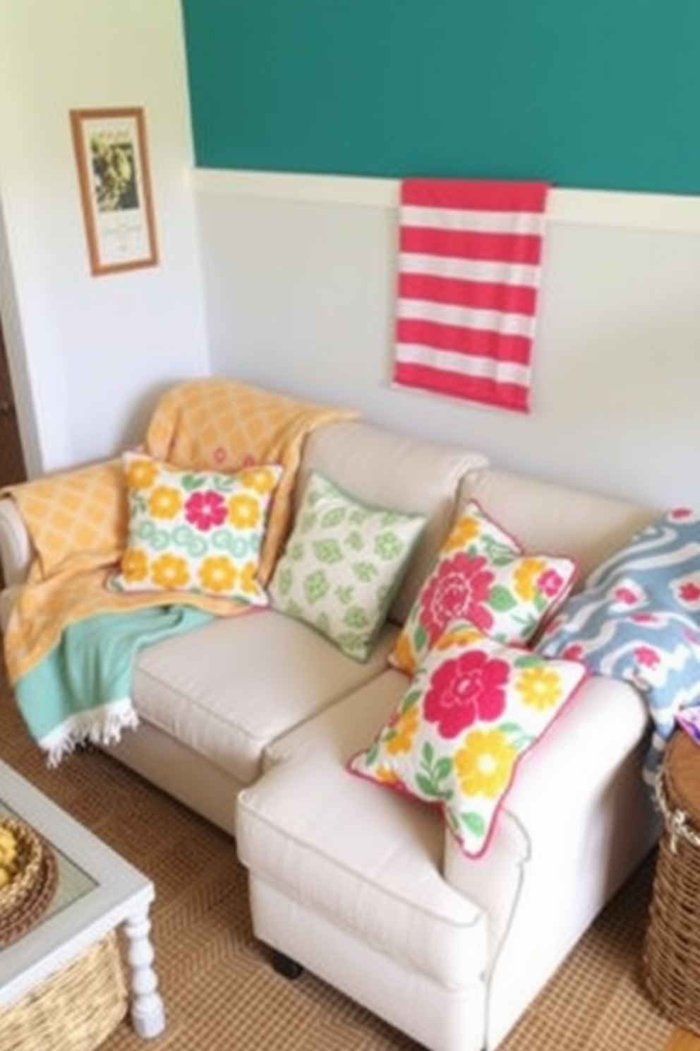 A small living room decorated for summer features playful patterns in throw blankets draped over a light-colored sofa. Bright cushions with floral designs complement the cheerful atmosphere, while a woven rug adds texture to the space.
