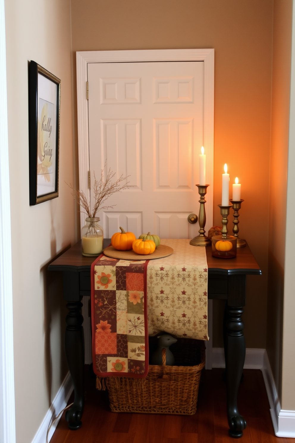 A beautifully styled hallway table adorned with a seasonal fabric runner featuring autumnal colors and patterns. The table is complemented by small decorative pumpkins and a warm candle arrangement, creating a cozy Thanksgiving atmosphere.