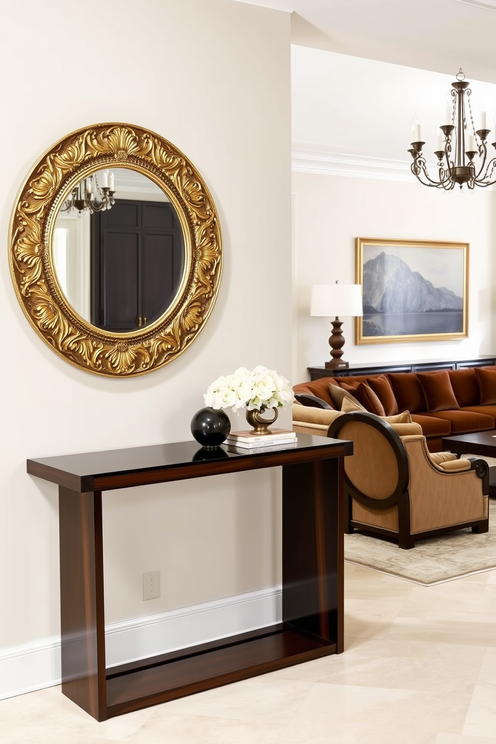 A sleek console table made of dark wood stands against the wall in the entryway. Above it, a large round mirror with an ornate gold frame reflects the soft light from a nearby chandelier. The living room features a plush sectional sofa upholstered in a rich velvet fabric. Complementing the sofa, a pair of antique armchairs with intricate carvings add a touch of elegance to the space.